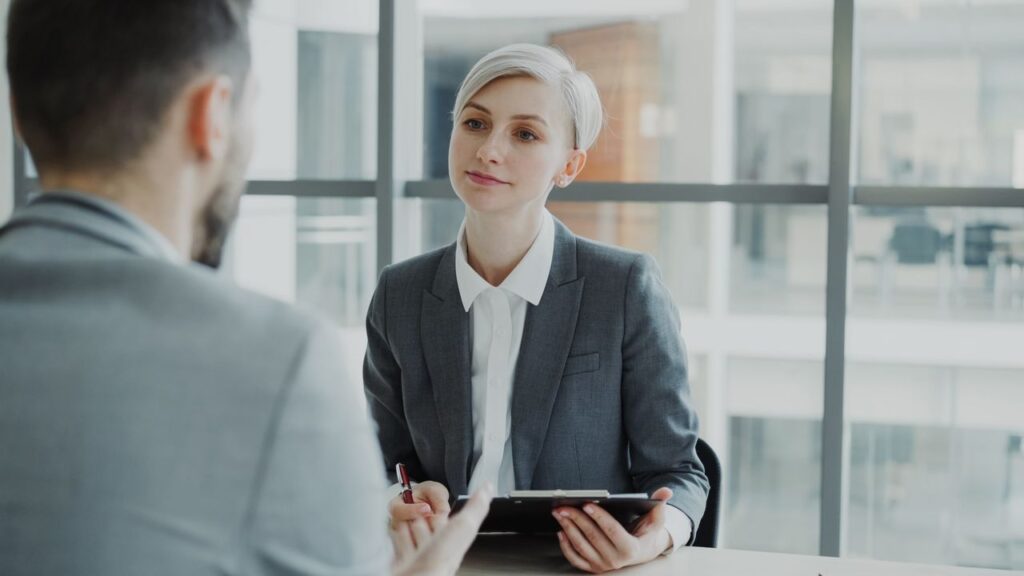 Mastering the First Impression: Your intriguing post title goes here Business meeting featuring two professionals in a modern office setting.