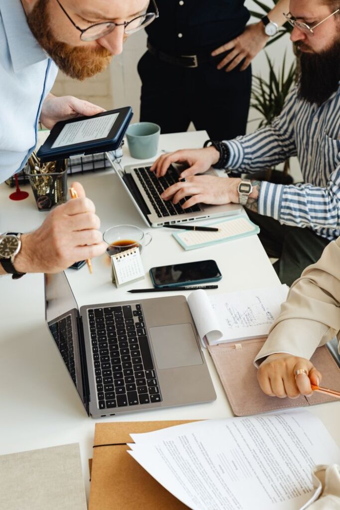 Crafting Captivating Headlines: Your awesome post title goes here Teamwork in action with technology, papers, and collaboration at a dynamic office desk.
